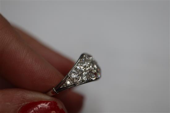 A white metal and diamond cluster set elliptical shaped ring, size H/I.